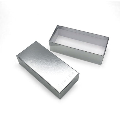 Silver-finish box lid beside the light-colored interior